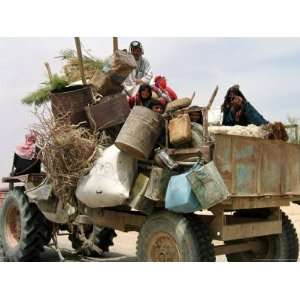  An Iraqi Family and Their Sheep Ride on Their Tractor to Fetch 