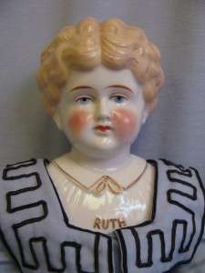   Name RUTH China head Doll with molded collar Dressed Ca.1910  
