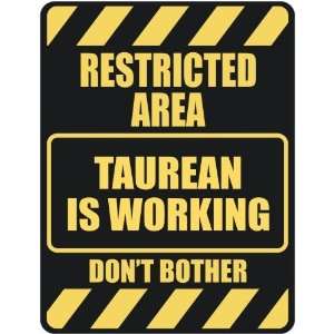   RESTRICTED AREA TAUREAN IS WORKING  PARKING SIGN