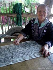   ladies preparing the indigo dye and drawing the batik patterns in wax