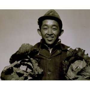  1943 Richard Kobayashi, farmer with cabbages, Manzanar 